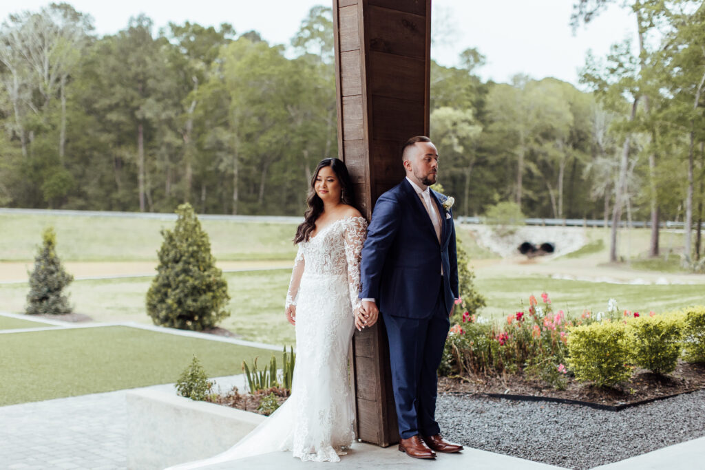 Couple shares first look during rainy day wedding