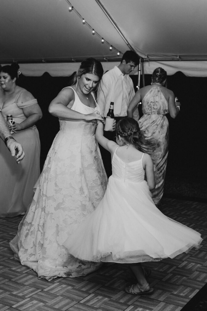 Bride twirls young girl