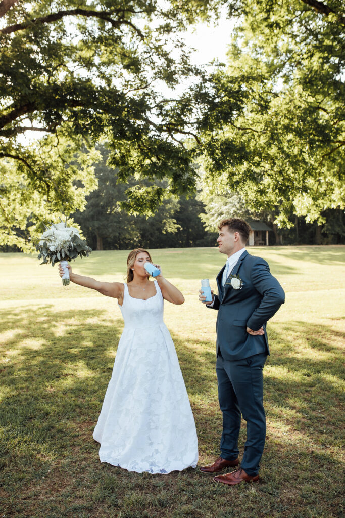 Bride and groom taking sips of drinks