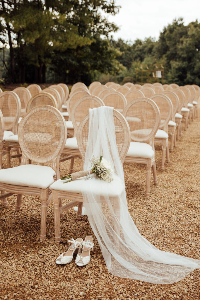 Wedding details of shoes, veil, and bouquet