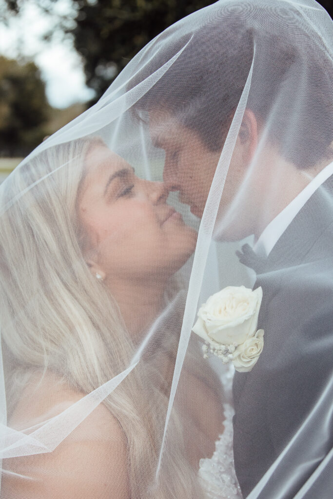 Bride and groom share an almost-kiss under her veil